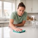 Shontina Dejene wiping a countertop during a residential cleaning visit